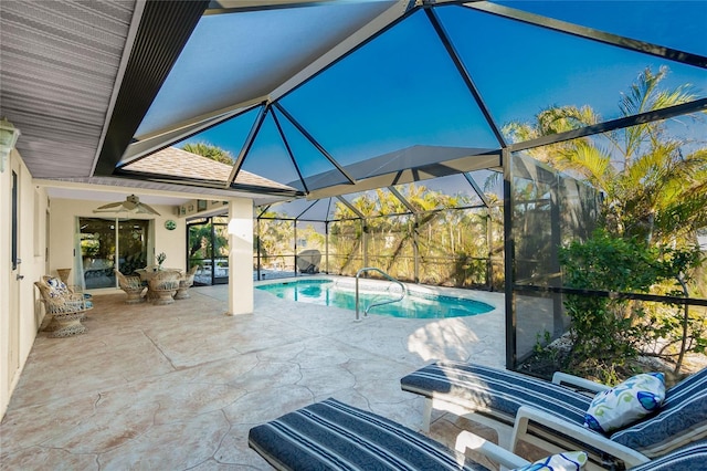 view of pool featuring ceiling fan, a lanai, and a patio