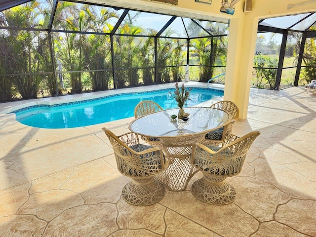 view of swimming pool with a lanai and a patio area