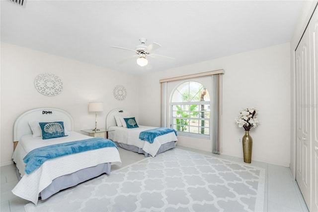 bedroom with ceiling fan and a closet