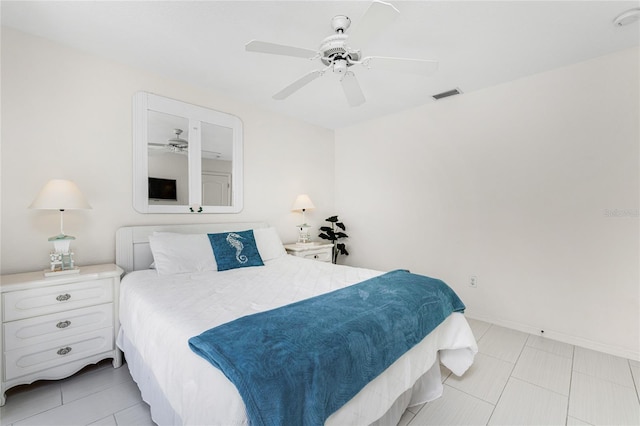 tiled bedroom featuring ceiling fan