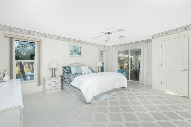 bedroom featuring access to exterior, multiple windows, and ceiling fan