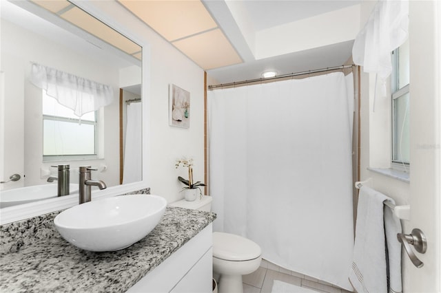 bathroom with tile patterned flooring, vanity, and toilet