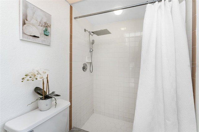 bathroom with curtained shower and toilet