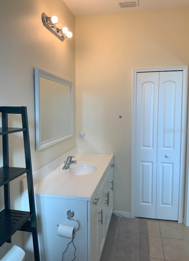 bathroom featuring tile patterned flooring and vanity