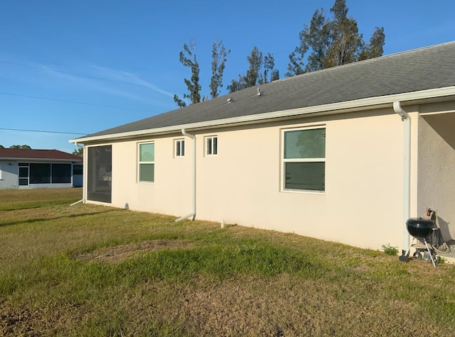 rear view of house featuring a yard