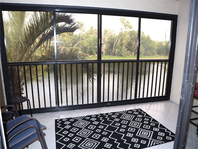 sunroom featuring a water view