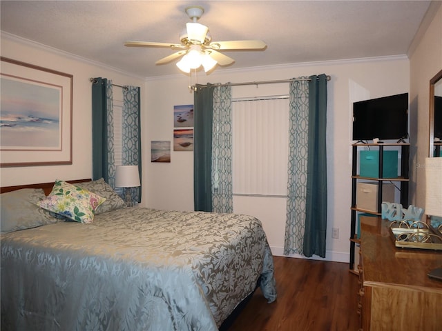 bedroom featuring dark hardwood / wood-style flooring, ceiling fan, and crown molding