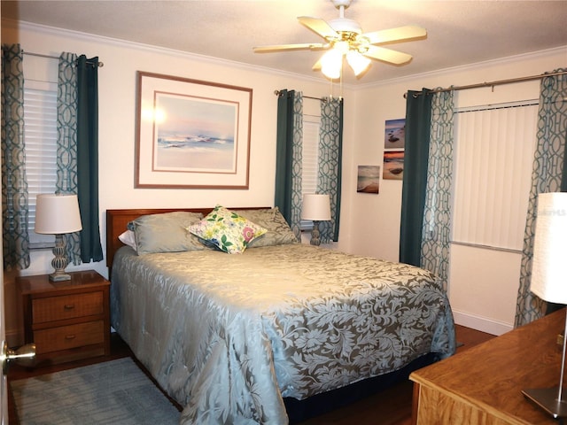 bedroom with ceiling fan, dark hardwood / wood-style floors, and ornamental molding