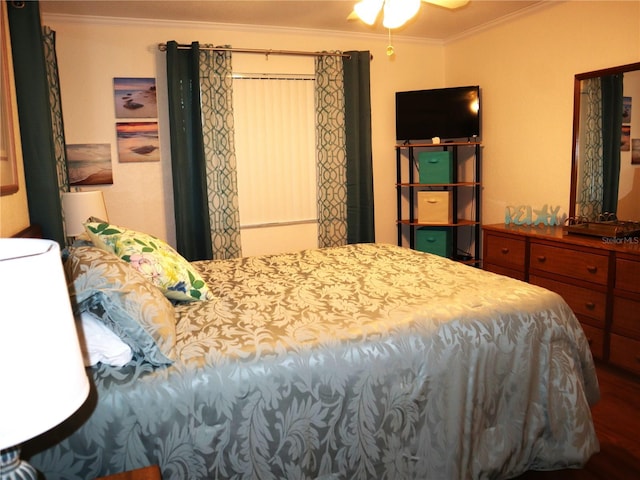 bedroom featuring ceiling fan, wood-type flooring, and ornamental molding