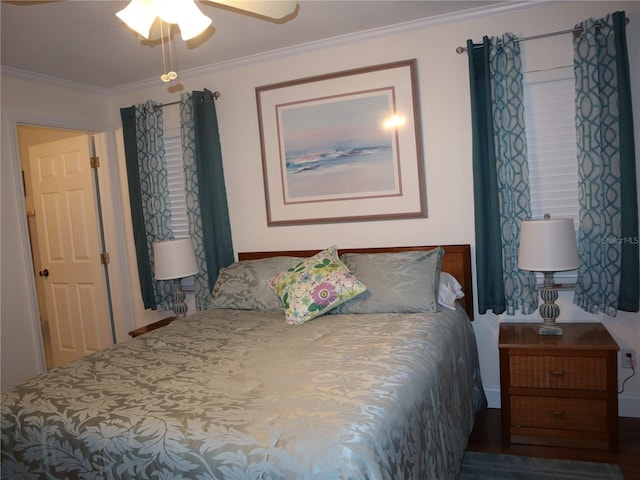 bedroom featuring dark hardwood / wood-style flooring, ceiling fan, and ornamental molding