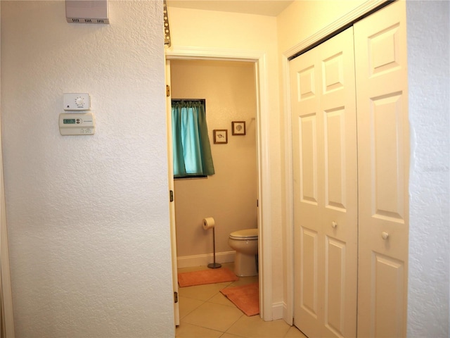 bathroom with tile patterned flooring and toilet