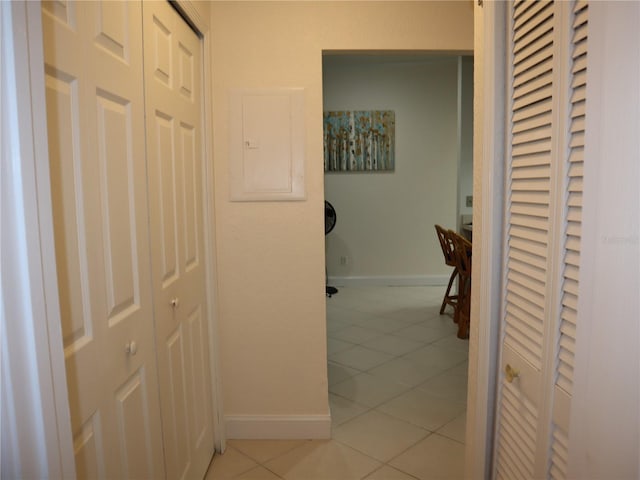 corridor with light tile patterned floors and electric panel