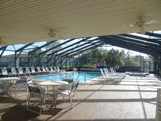 view of pool featuring a lanai, a patio area, and ceiling fan