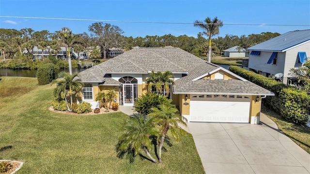 view of front of home with a front yard and a garage