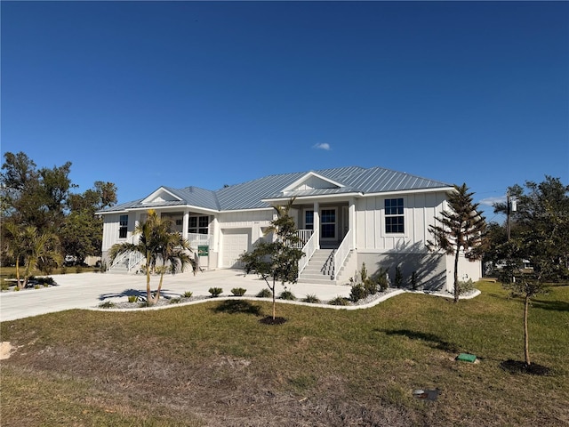 view of front of home with a front yard and a garage