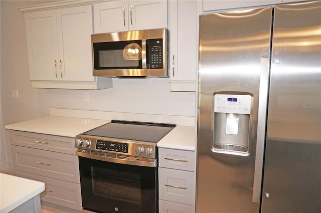 kitchen with appliances with stainless steel finishes and gray cabinets