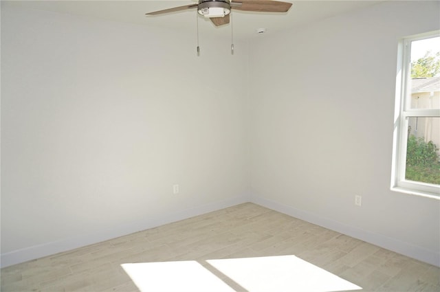 empty room with ceiling fan and light wood-type flooring