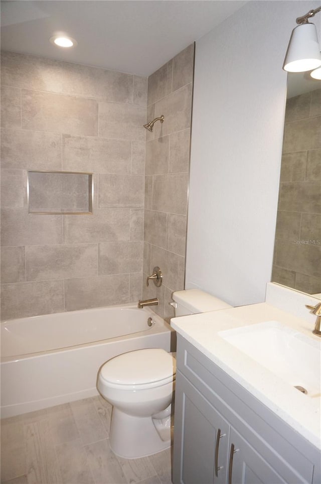 full bathroom with vanity, toilet, and tiled shower / bath