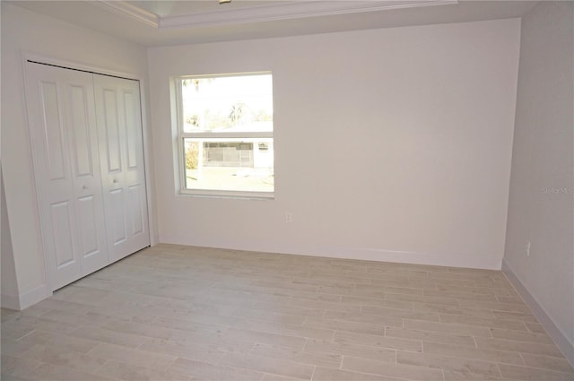 unfurnished bedroom featuring light wood-type flooring and a closet