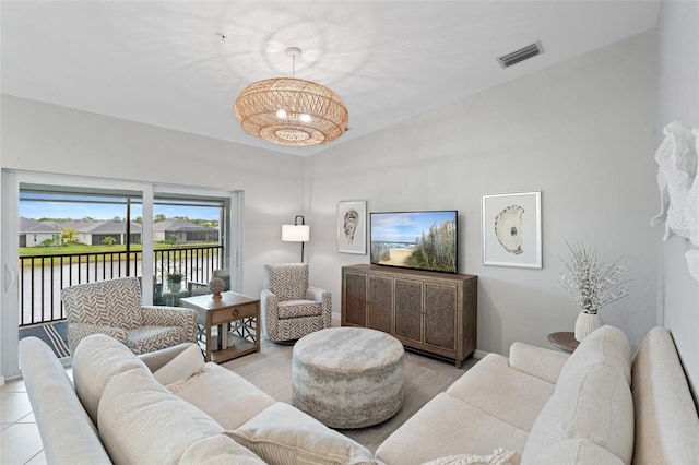 living room with light tile patterned flooring and a water view