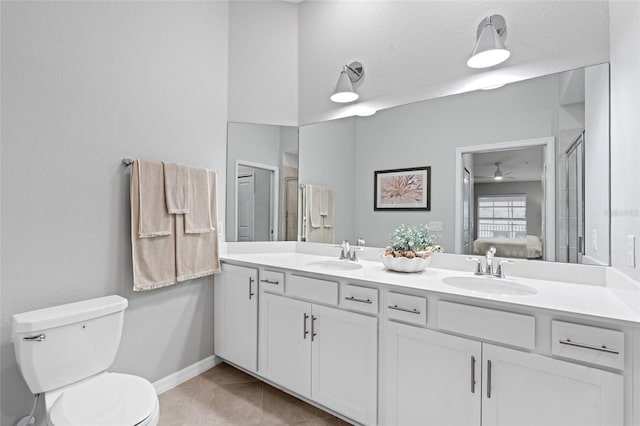 bathroom with tile patterned flooring, vanity, ceiling fan, toilet, and a textured ceiling