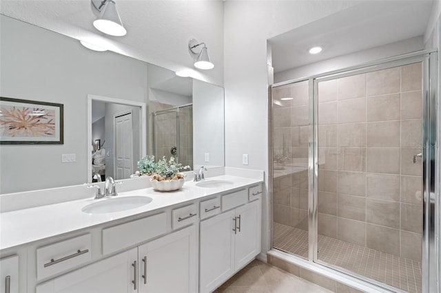 bathroom with walk in shower, tile patterned floors, and vanity