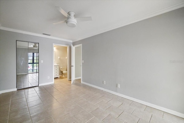 spare room featuring ceiling fan, light tile patterned floors, and ornamental molding