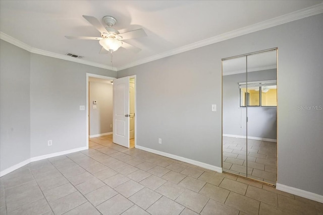 unfurnished bedroom featuring light tile patterned floors, a closet, ceiling fan, and ornamental molding