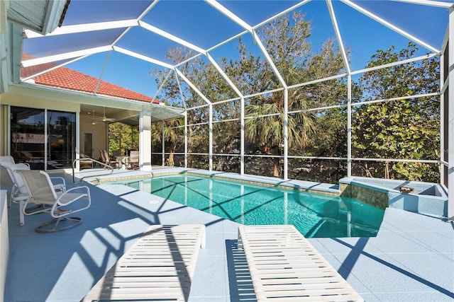 view of swimming pool with a patio area, ceiling fan, and glass enclosure