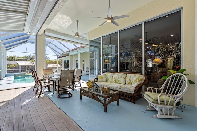 exterior space featuring glass enclosure, ceiling fan, and an outdoor hangout area