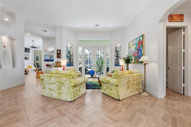 tiled living room with crown molding, french doors, and ceiling fan