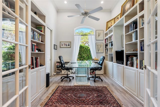 office area featuring light hardwood / wood-style flooring, ceiling fan, and crown molding