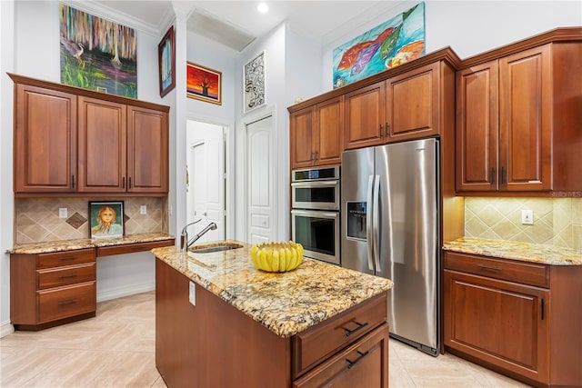 kitchen featuring appliances with stainless steel finishes, tasteful backsplash, light stone counters, and sink