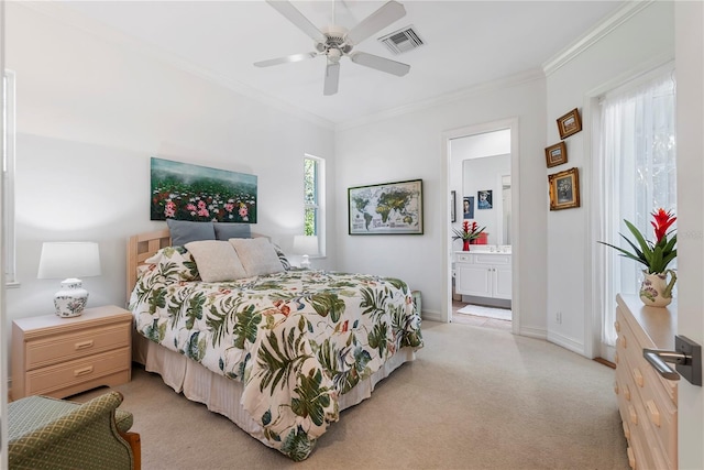 carpeted bedroom featuring ceiling fan, crown molding, and ensuite bath