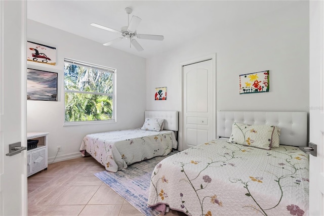 tiled bedroom featuring a closet and ceiling fan