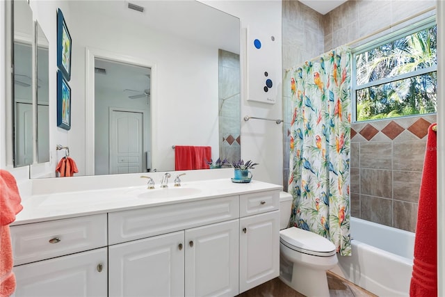 full bathroom with vanity, shower / bath combo, ceiling fan, toilet, and wood-type flooring