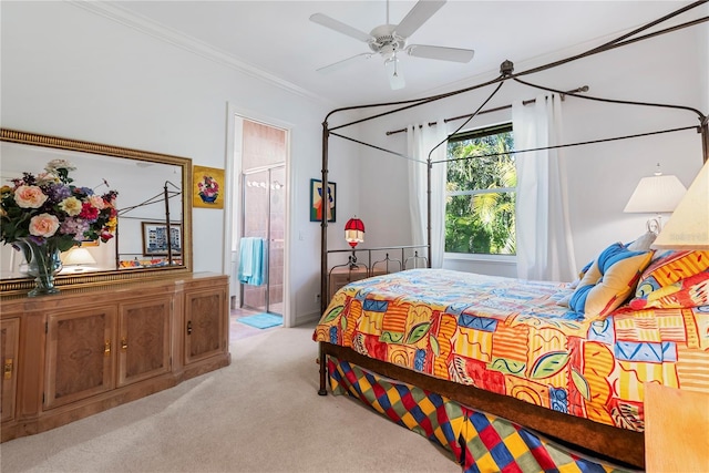 carpeted bedroom featuring ceiling fan, ornamental molding, and ensuite bath