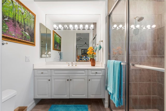 bathroom with vanity, toilet, and a shower with shower door