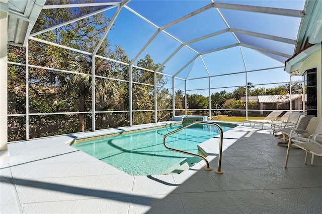 view of swimming pool featuring a lanai and a patio area