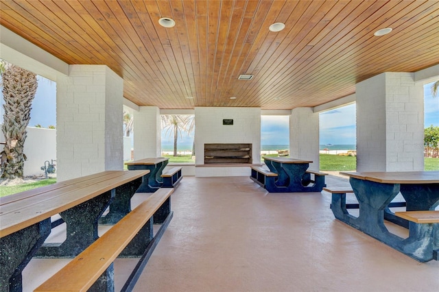 view of patio featuring a water view and a bar