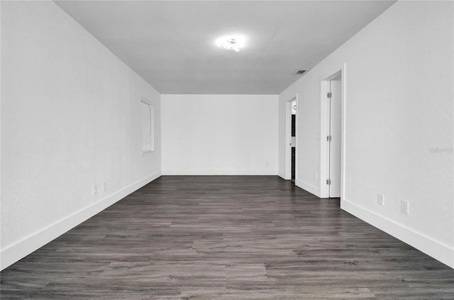 empty room featuring dark wood-type flooring