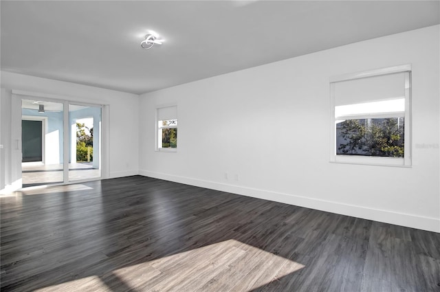 unfurnished room with dark hardwood / wood-style floors