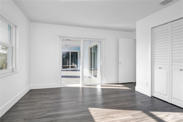 unfurnished room featuring dark hardwood / wood-style floors