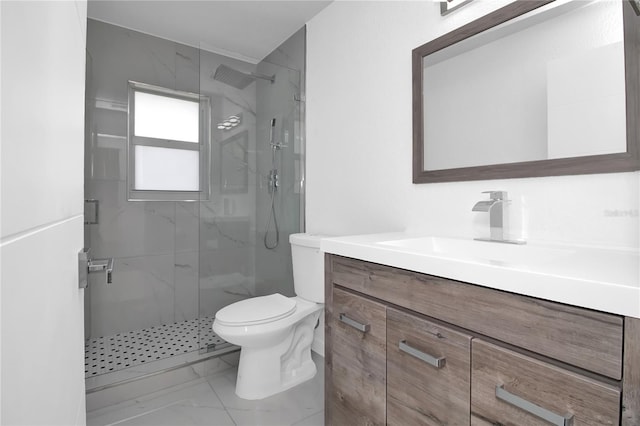 bathroom featuring vanity, an enclosed shower, and toilet