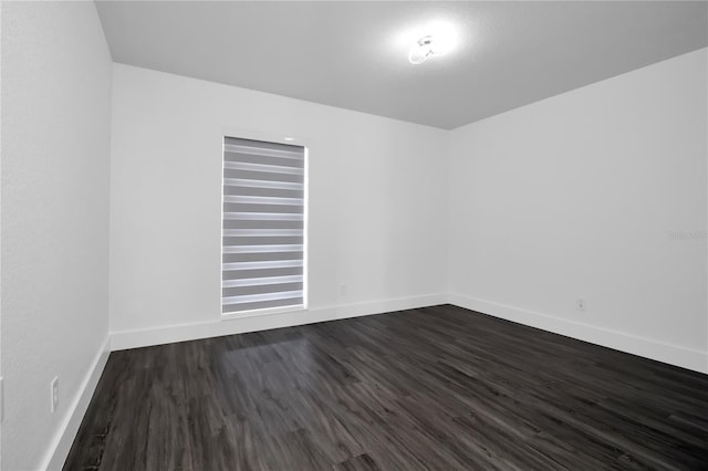 spare room featuring dark wood-type flooring