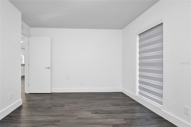 unfurnished room featuring dark hardwood / wood-style flooring