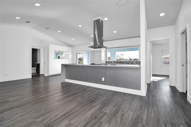 kitchen with white cabinets, island exhaust hood, dark wood-type flooring, and vaulted ceiling