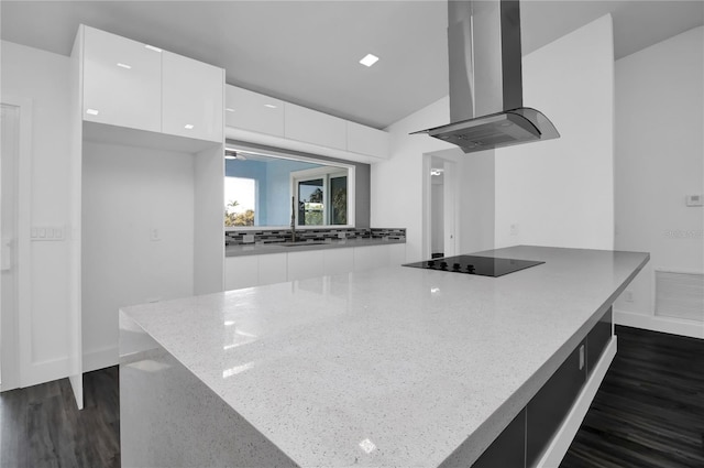 kitchen with island exhaust hood, black electric stovetop, white cabinets, and dark hardwood / wood-style floors