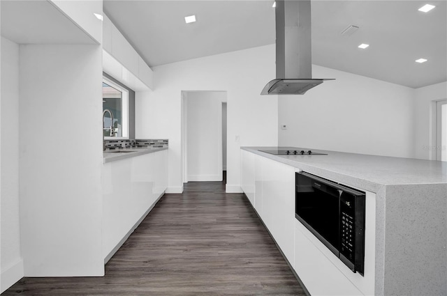 kitchen featuring white cabinetry, dark hardwood / wood-style floors, island exhaust hood, vaulted ceiling, and black appliances