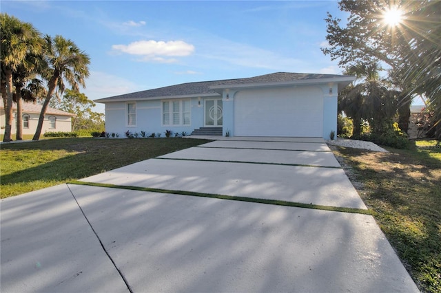 ranch-style home with a front yard and a garage